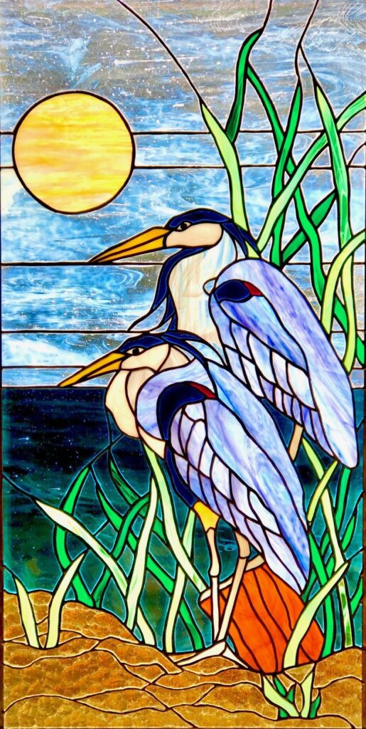 Stained glass heron sunset scene.