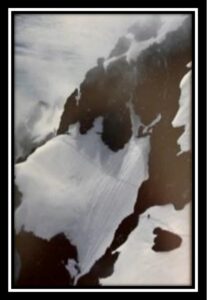 Aerial view of snowy mountain peak.